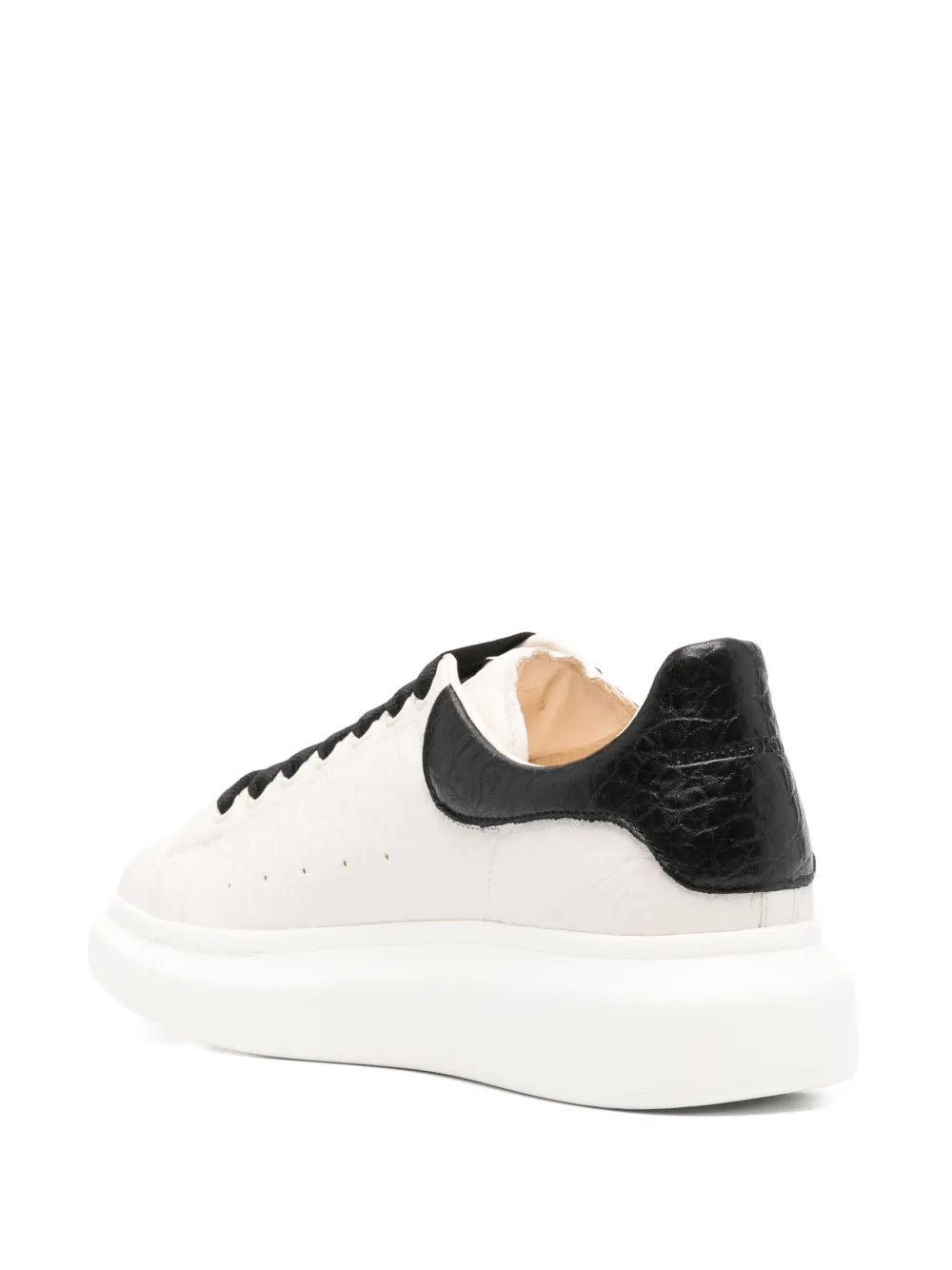 Back view oversized sneakers with black heel, cream body, and almond beige lining