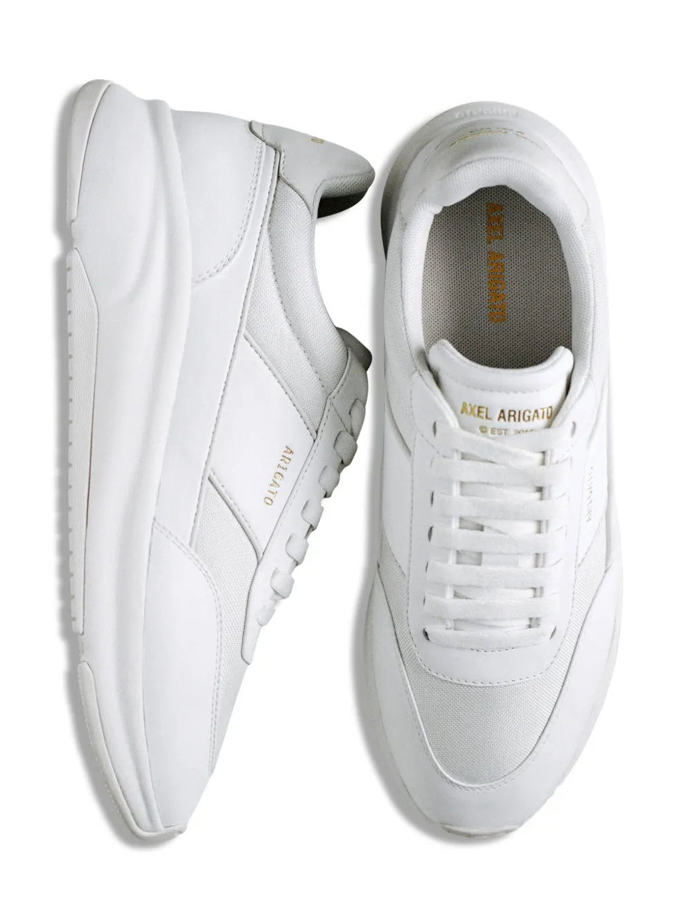 Pair of white low-top sneakers side by side showing lace-up uppers