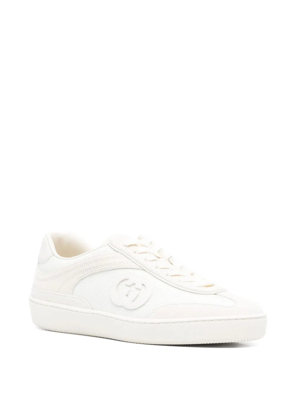 White low-top lace-up sneaker, front 3/4 view, embossed side logo
