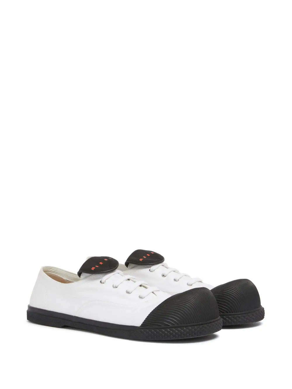 Pair of white low-top sneakers with black heel counter and black rubber toe caps