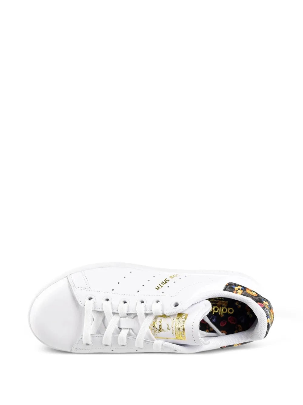 White sneaker with white laces and multicolor fabric lining near tongue