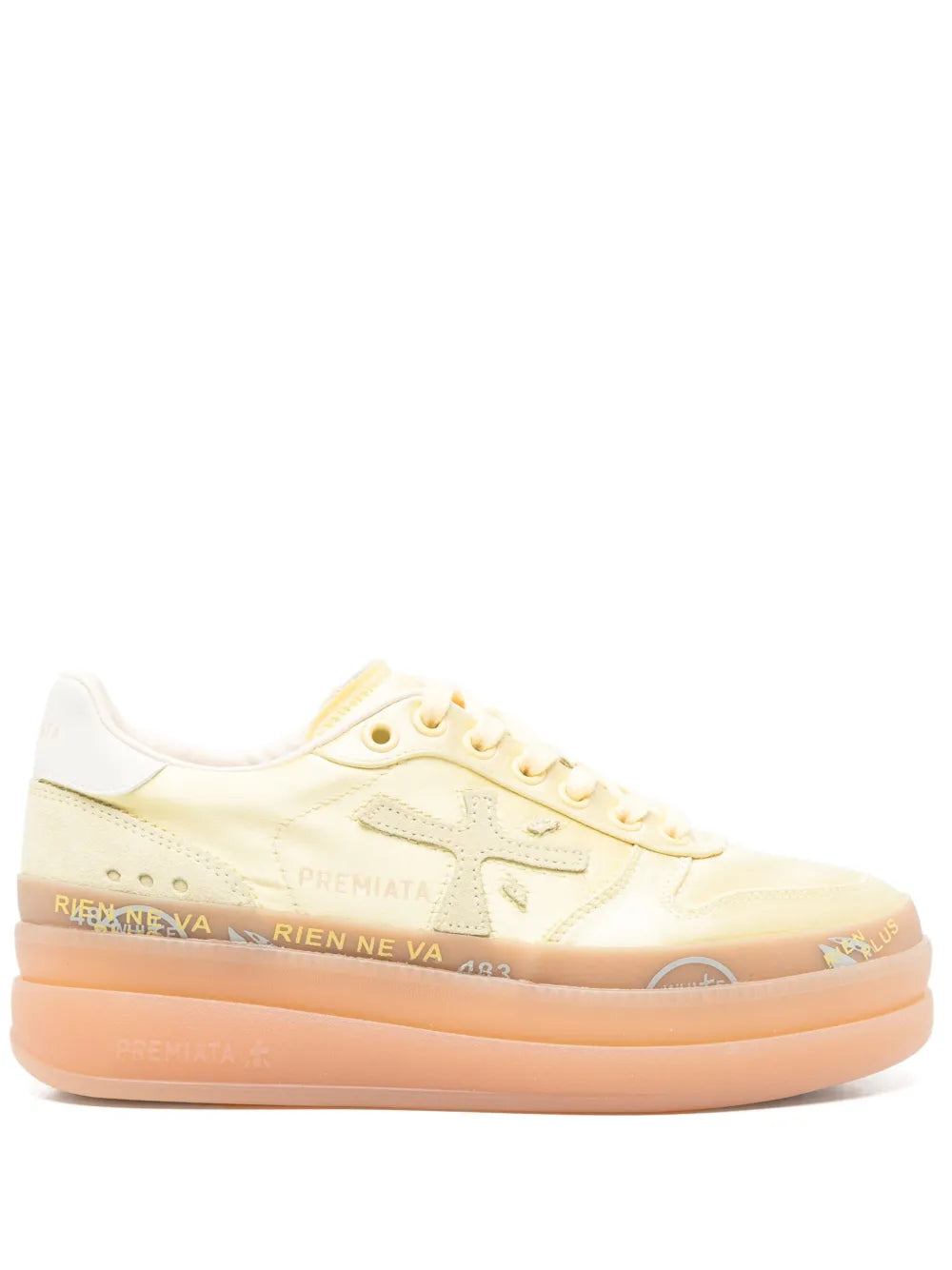 Pale yellow lace-up sneakers with white paneling and orange platform sole