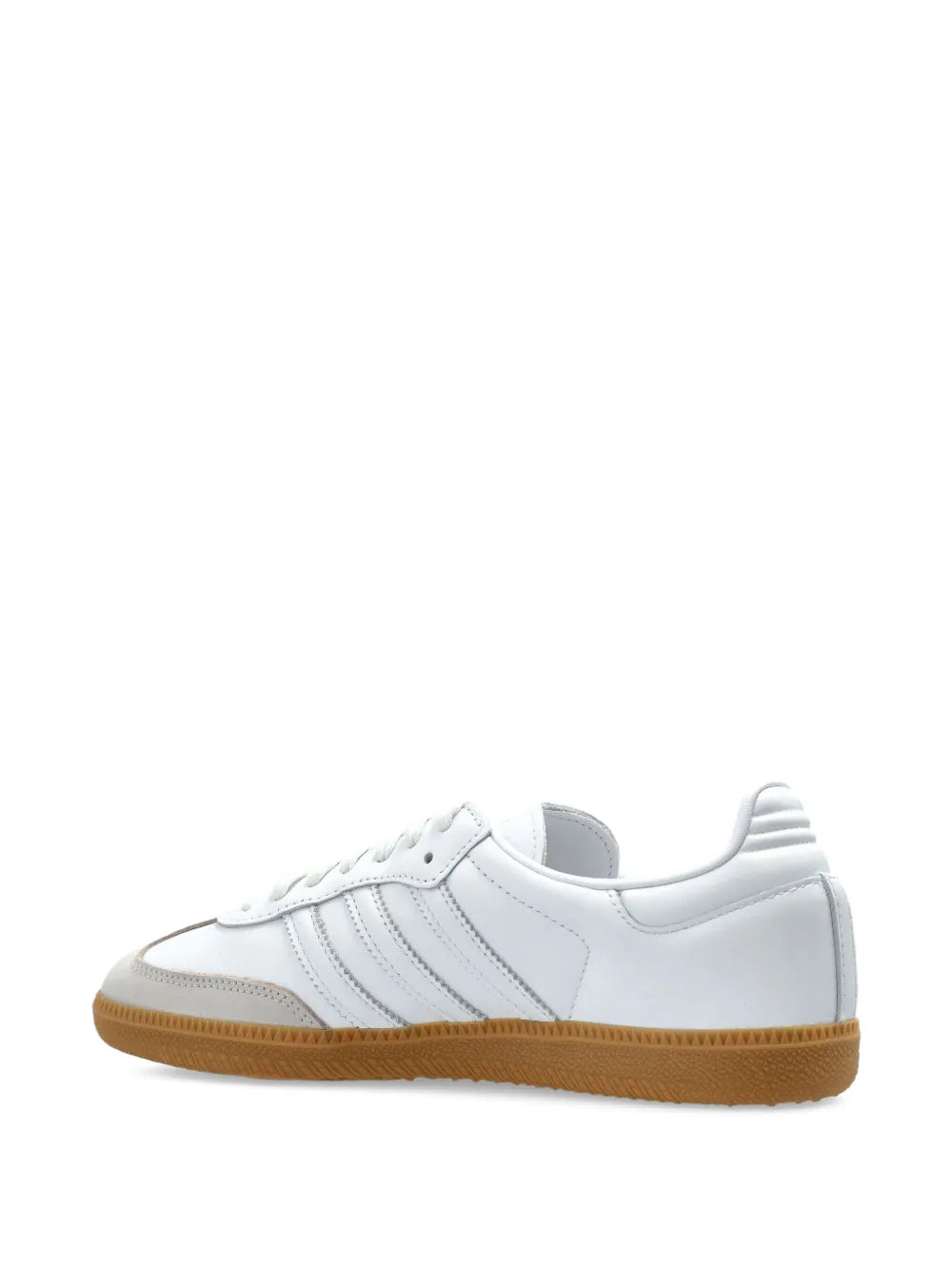 White adidas low-top sneakers with lace-up front and gum sole, angled view