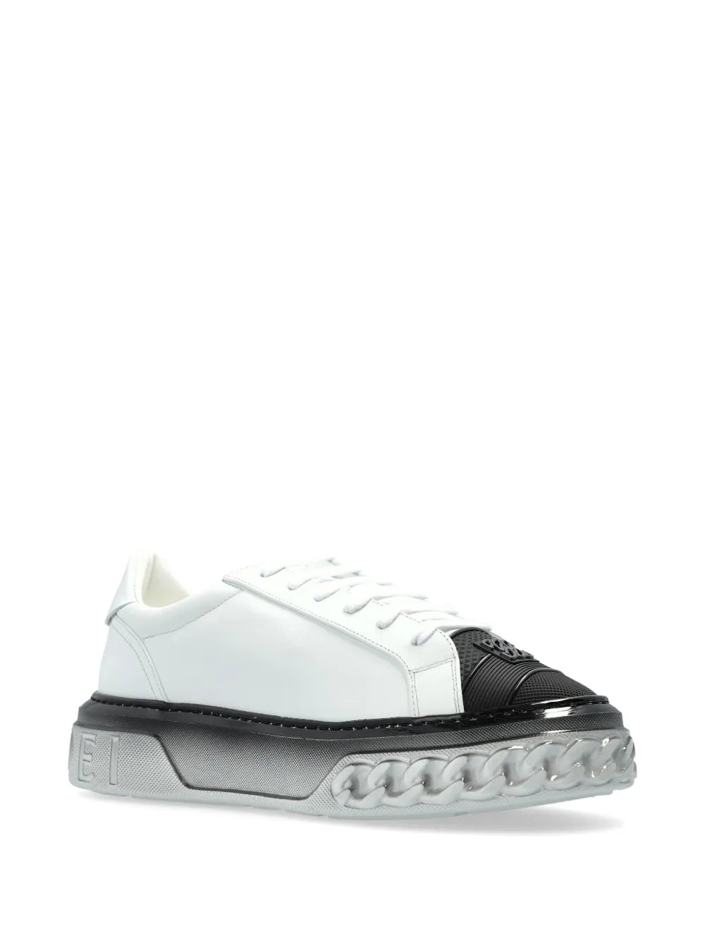 White low-top sneakers with black heel panel, lace-up front, and grippy sole.