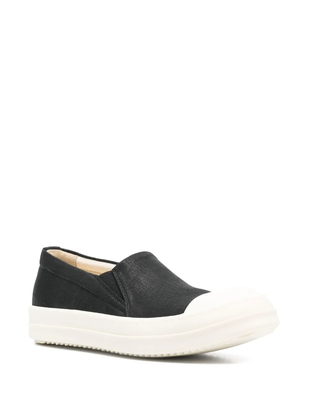 Black slip-on boat sneaker with white ridged sole and textured upper