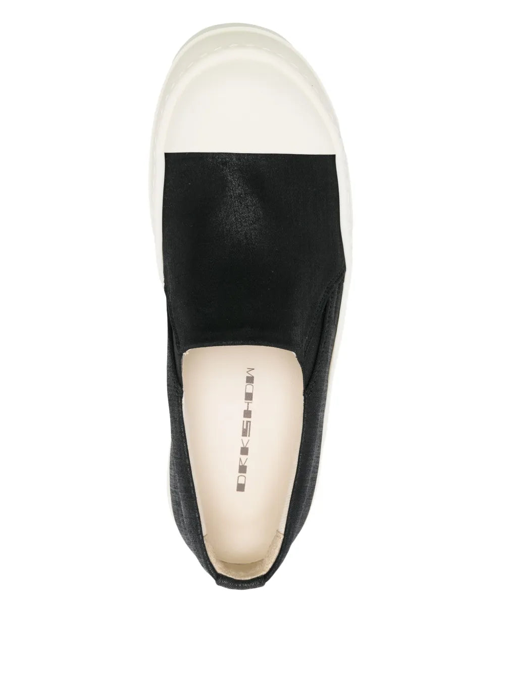 Black slip-on boat sneaker showing beige insole and open heel collar