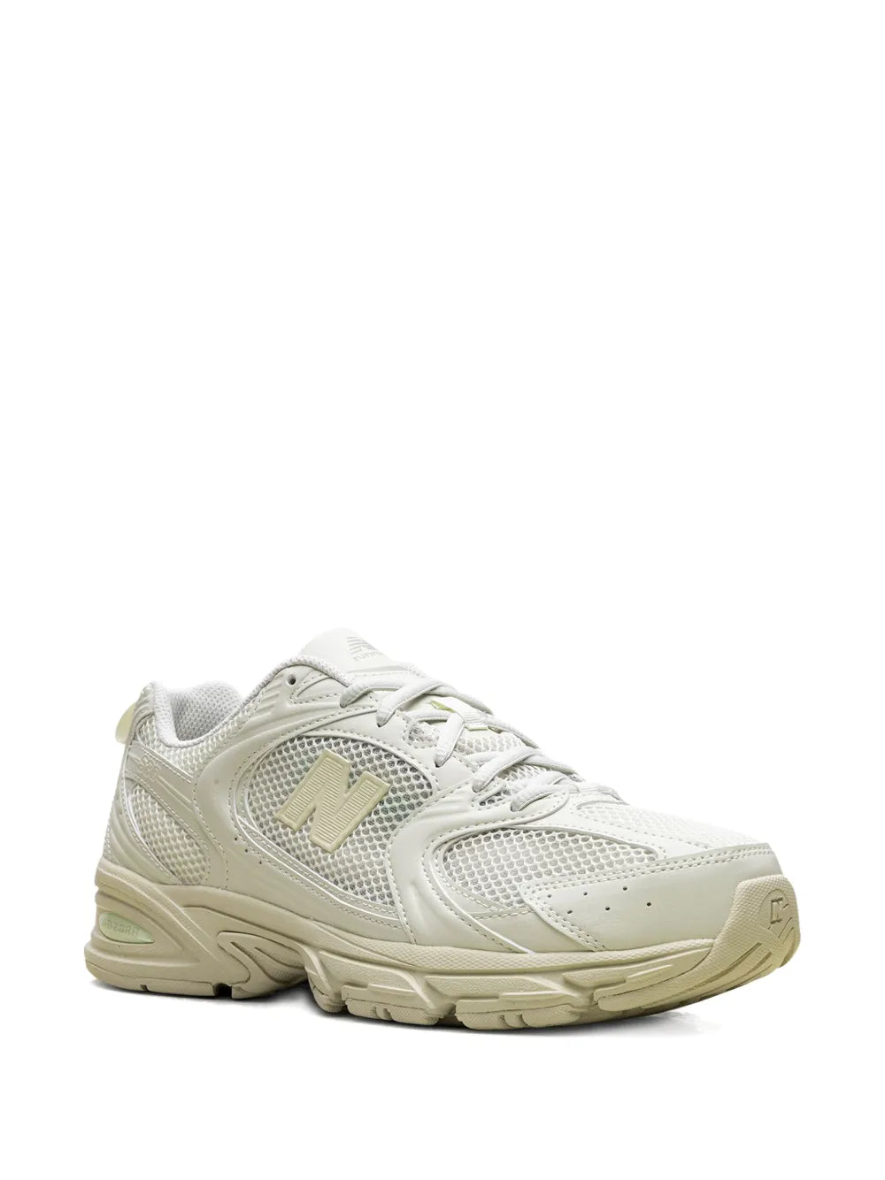 White low-top sneaker with gold N emblem, lace-up front, and padded collar