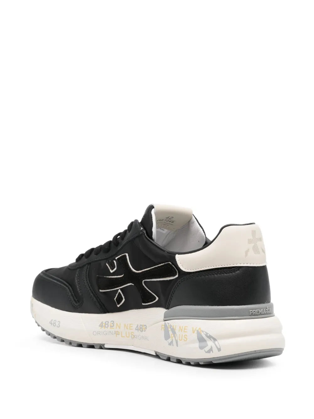Black lace-up sneakers with light heel trim, rear logo detail, and chunky midsole