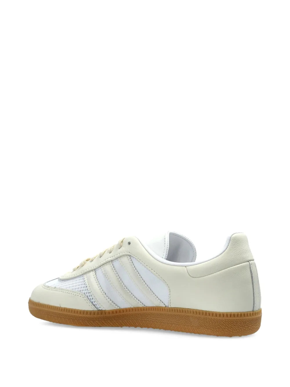 Side view of light beige low-top sneaker with blue stripes and gum sole
