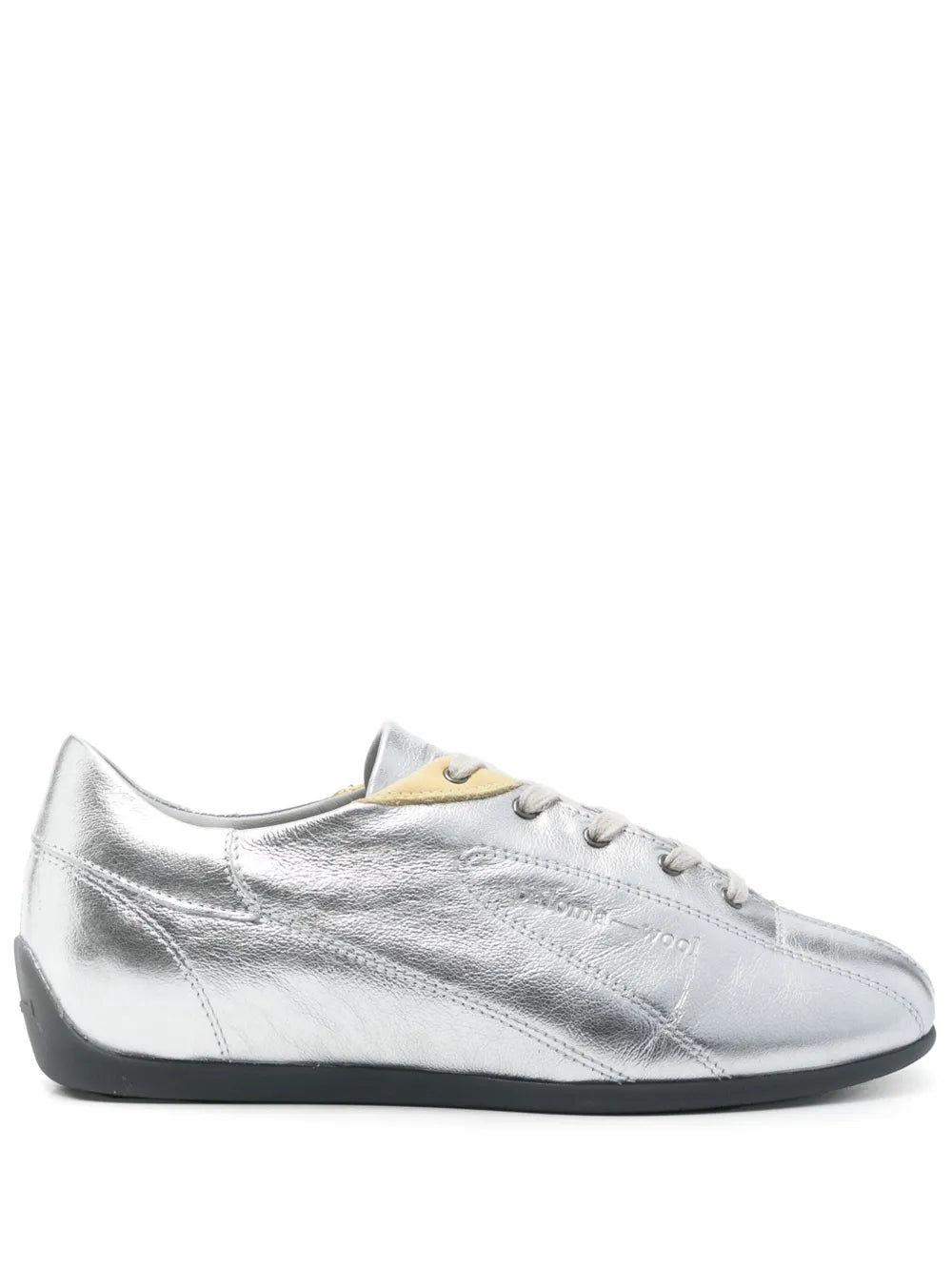 Metallic silver low-top sneaker with black sole and cream/yellow collar patch