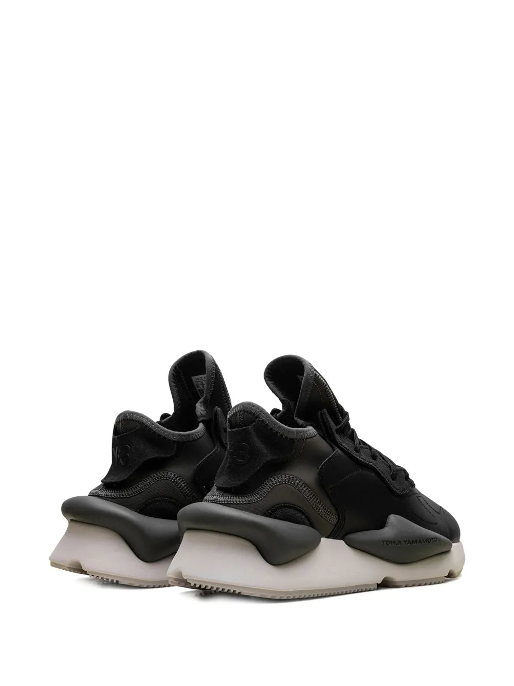 Pair of black lace-up sneakers with chunky midsoles and heel pull tabs