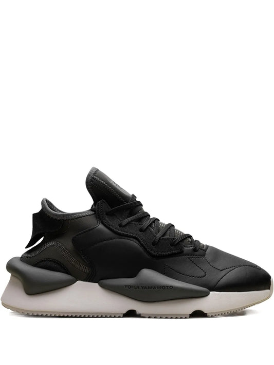 Black lace-up sneaker with sculpted side panels and white rubber sole