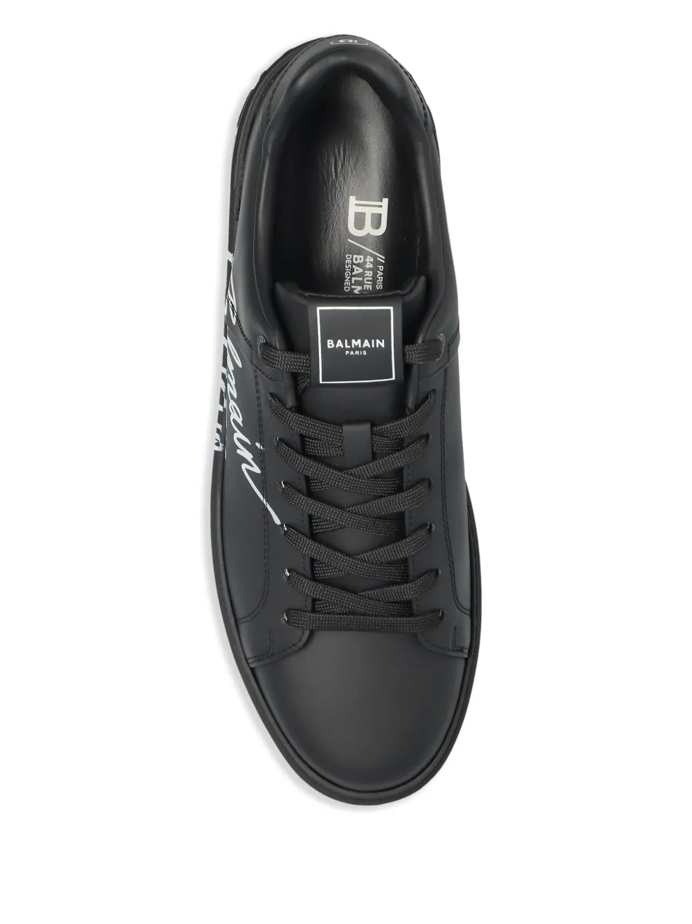 Black leather sneaker close-up with lace-up and tongue logo patch