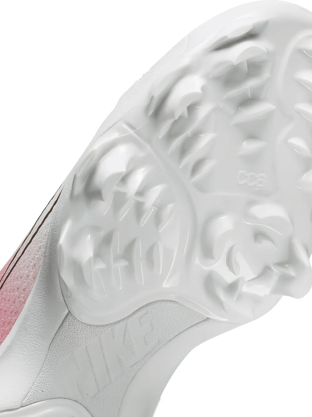 Soccer cleat outsole close-up with molded traction studs and embossed pattern