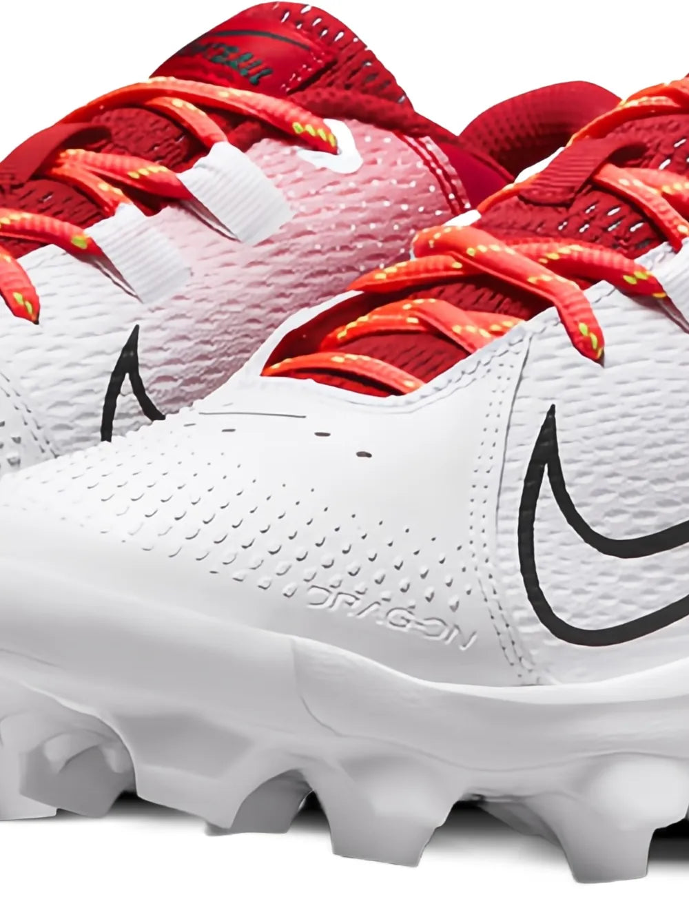 Close-up soccer cleat with white textured upper, black swoosh, and red laces