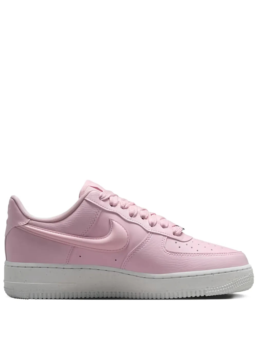 Pink low-top sneakers with Nike Swoosh, lace-up front, and rubber sole