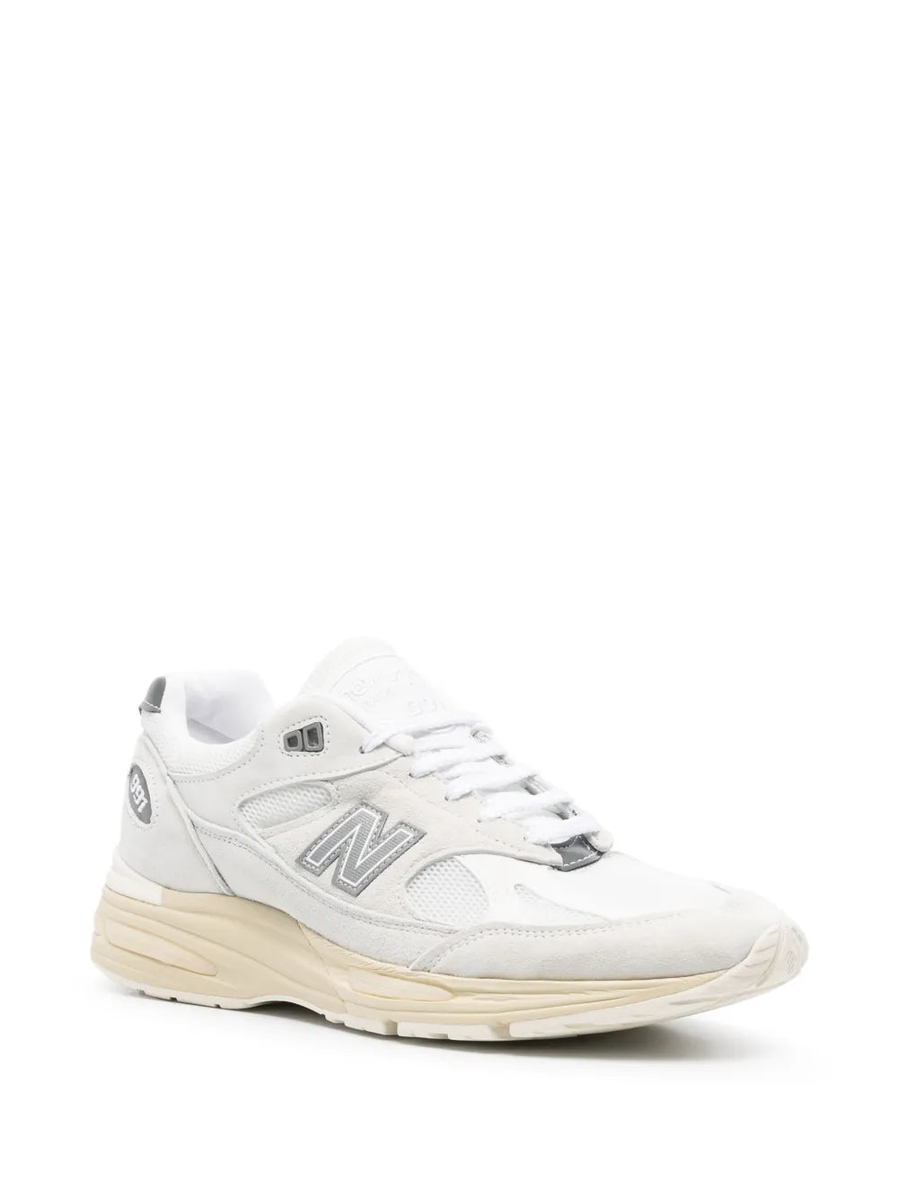 White New Balance 991V2 sneakers with 'N' logo, angled side view