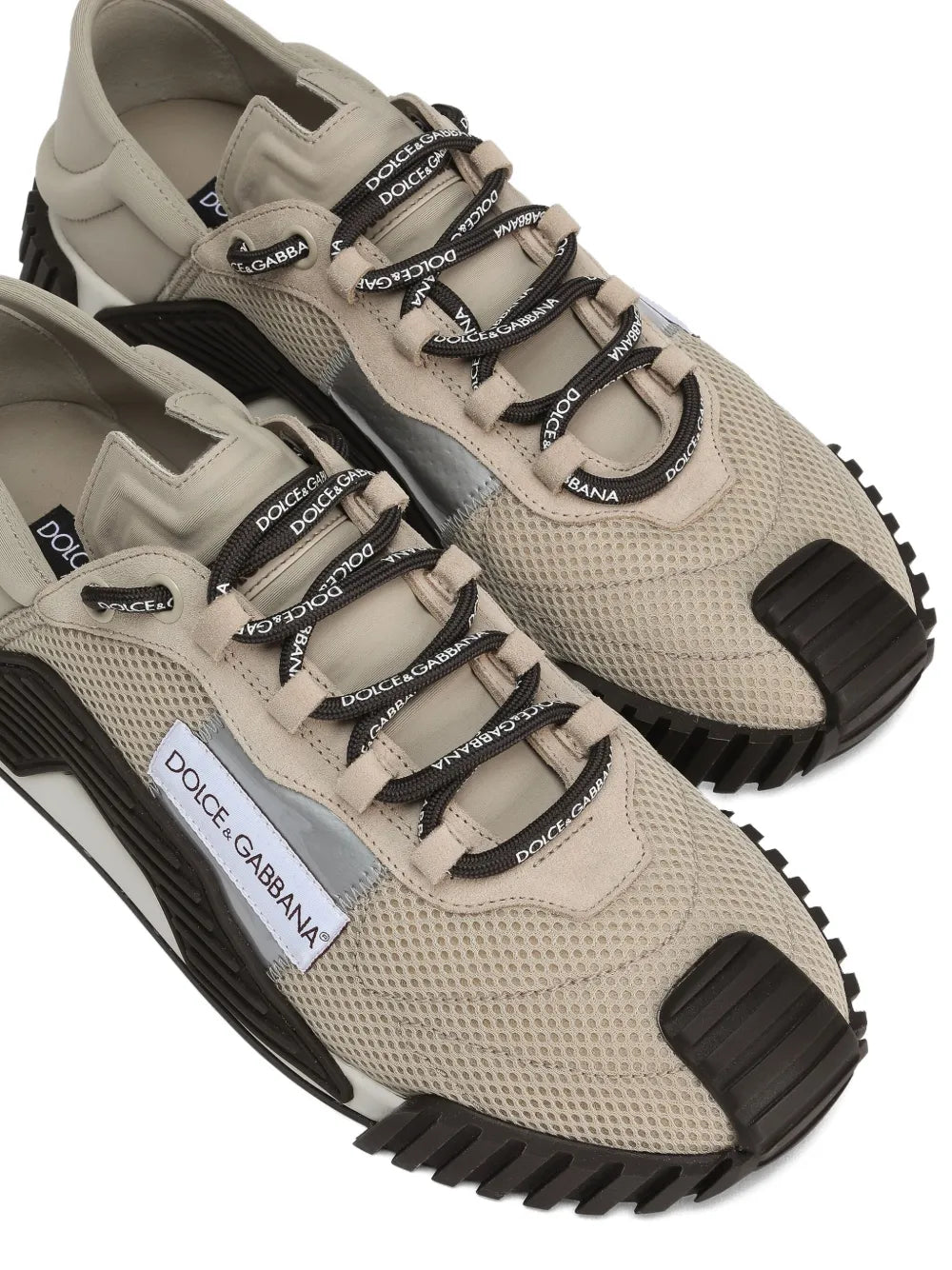Beige mesh-panel sneakers close-up with lace straps and Dolce & Gabbana logo, black sole