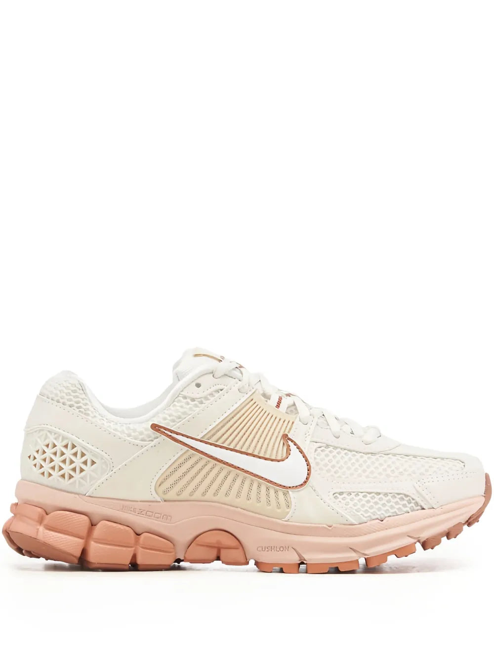 Cream running sneakers with orange Nike swoosh and cushioned foam sole