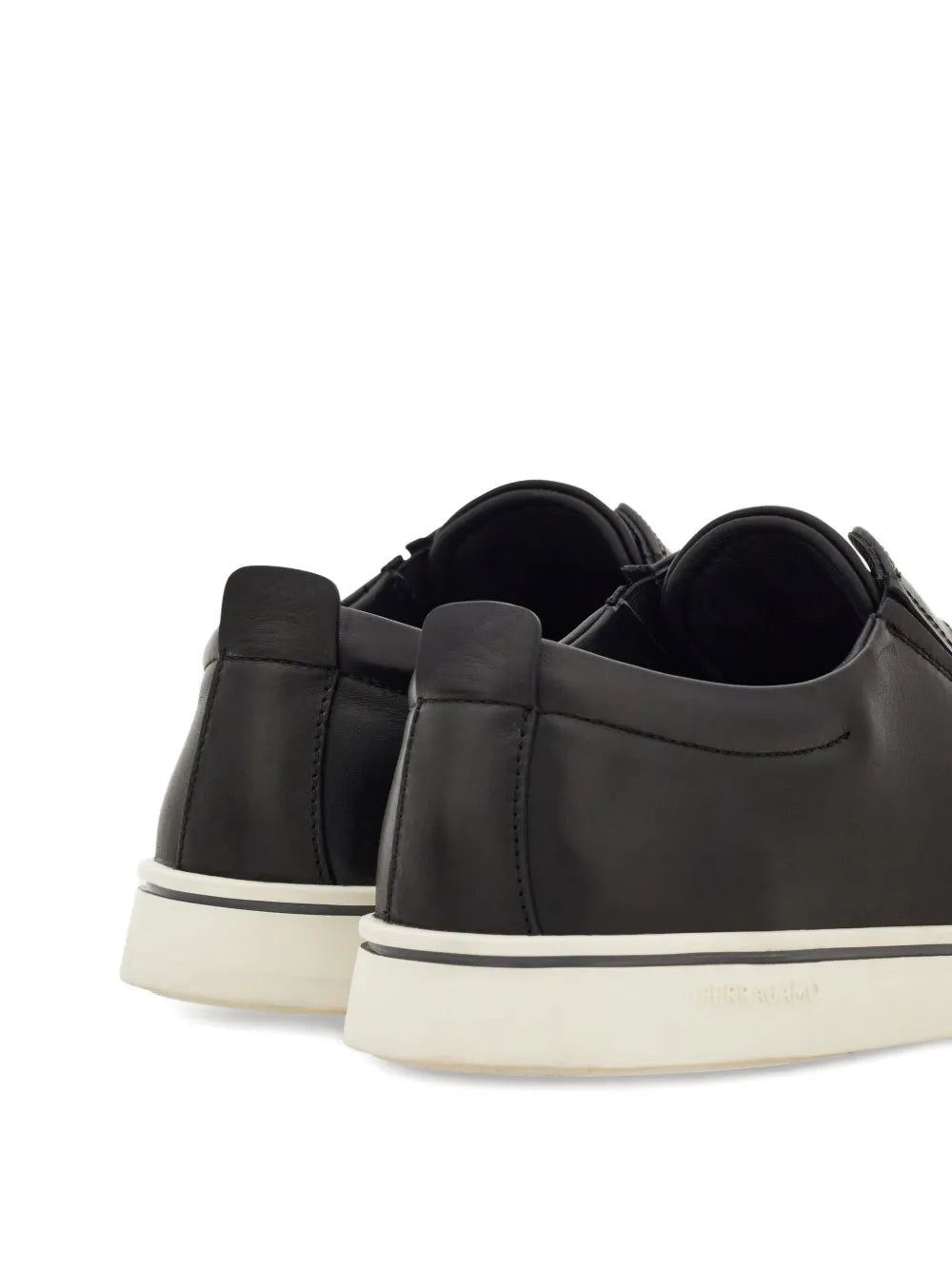 Ferragamo black leather slip-on sneakers from heel view, white rubber sole