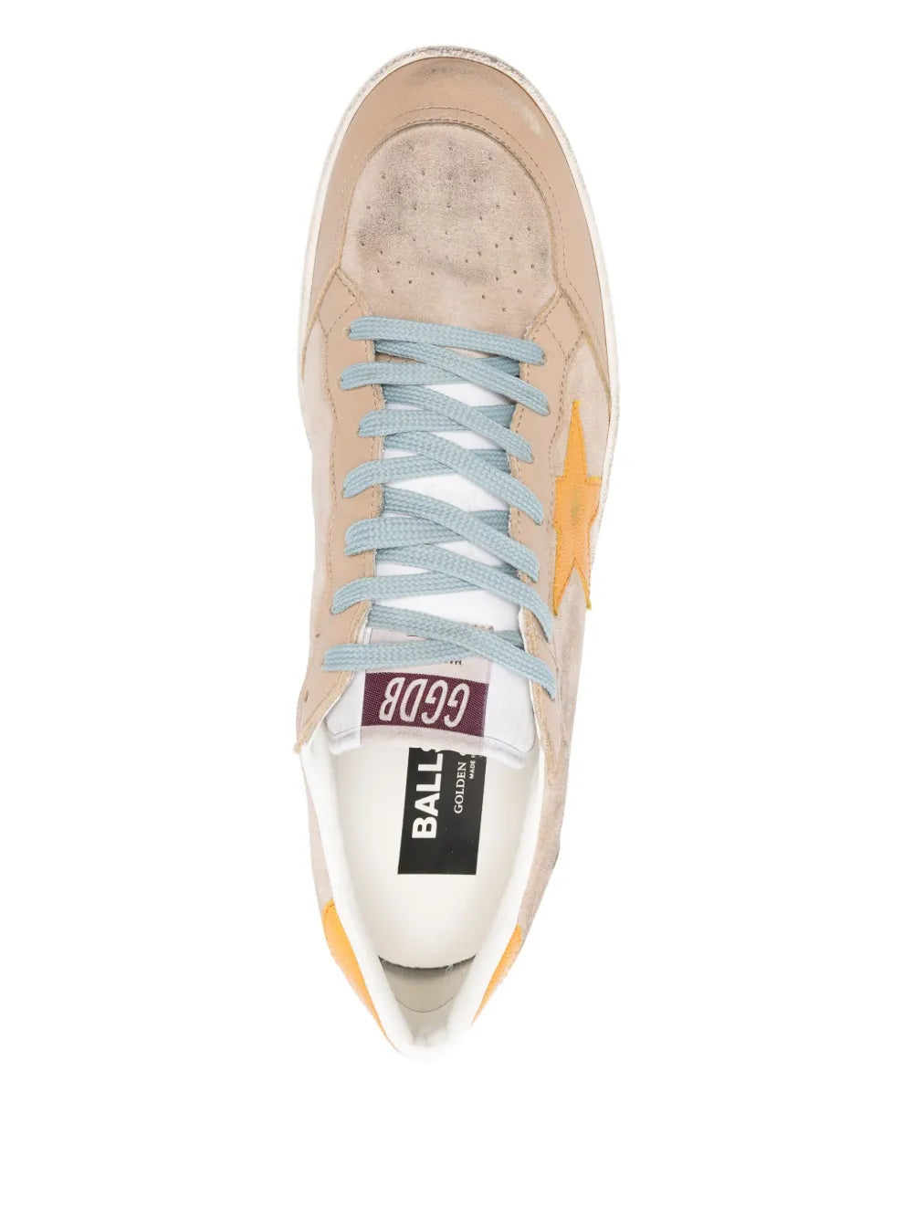 Beige low-top sneaker with light blue laces and tongue label detail; front view