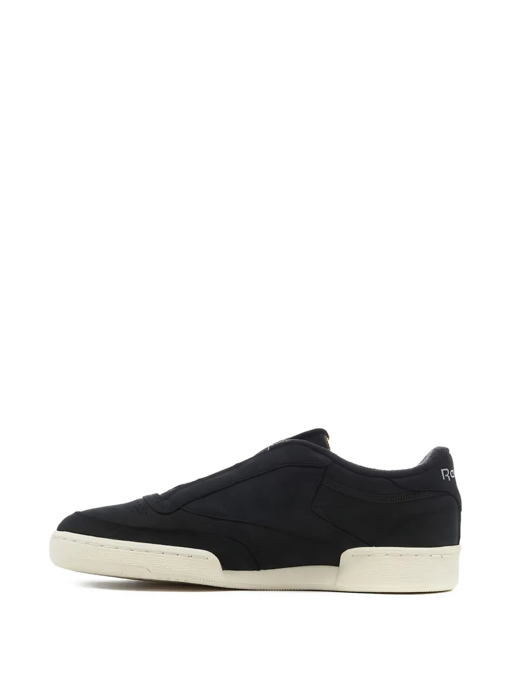Black low-top sneakers with white midsole and minimal logo accents