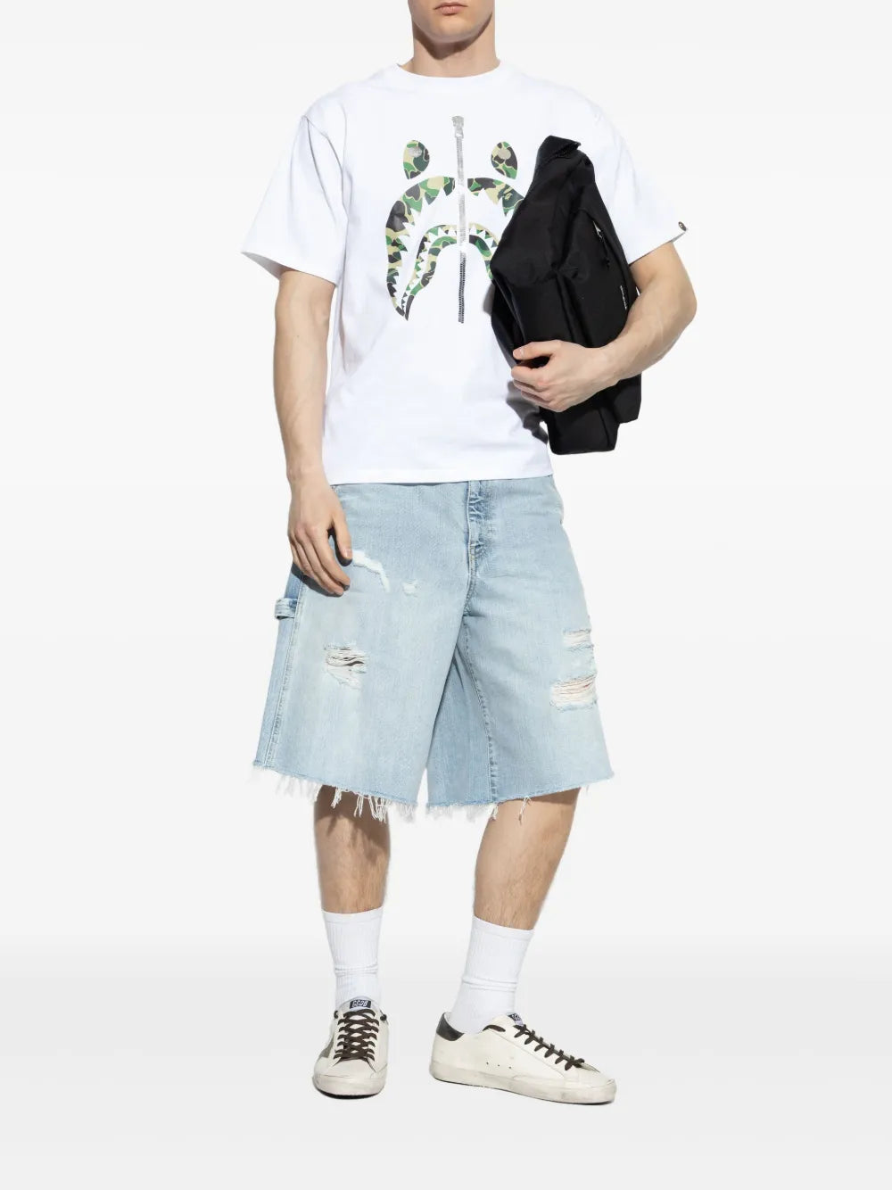Golden Goose Super Star sneakers on model, white leather with brown laces and gold star