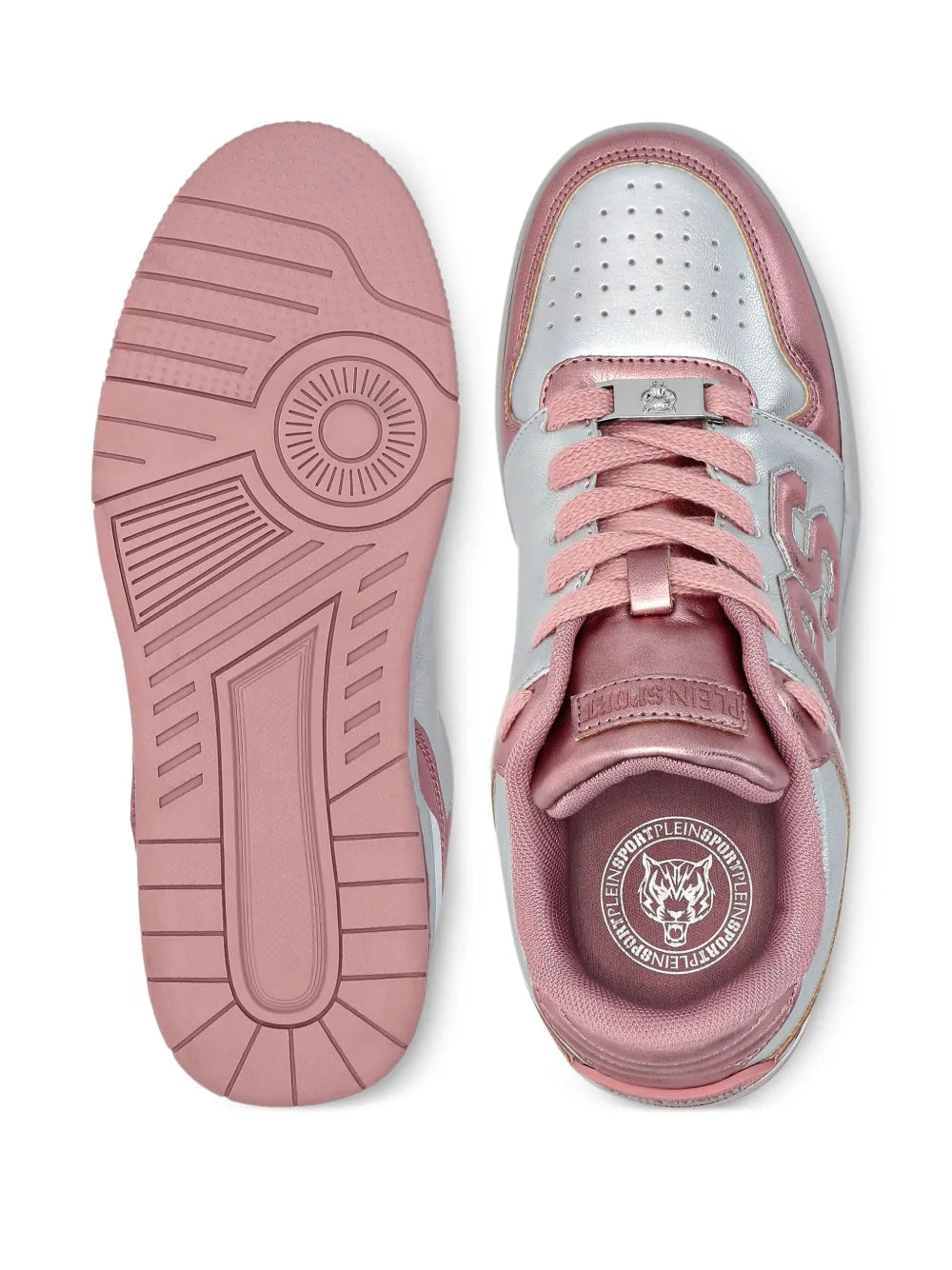 Pink rubber outsole and white interior of lace-up sneakers with logo badge