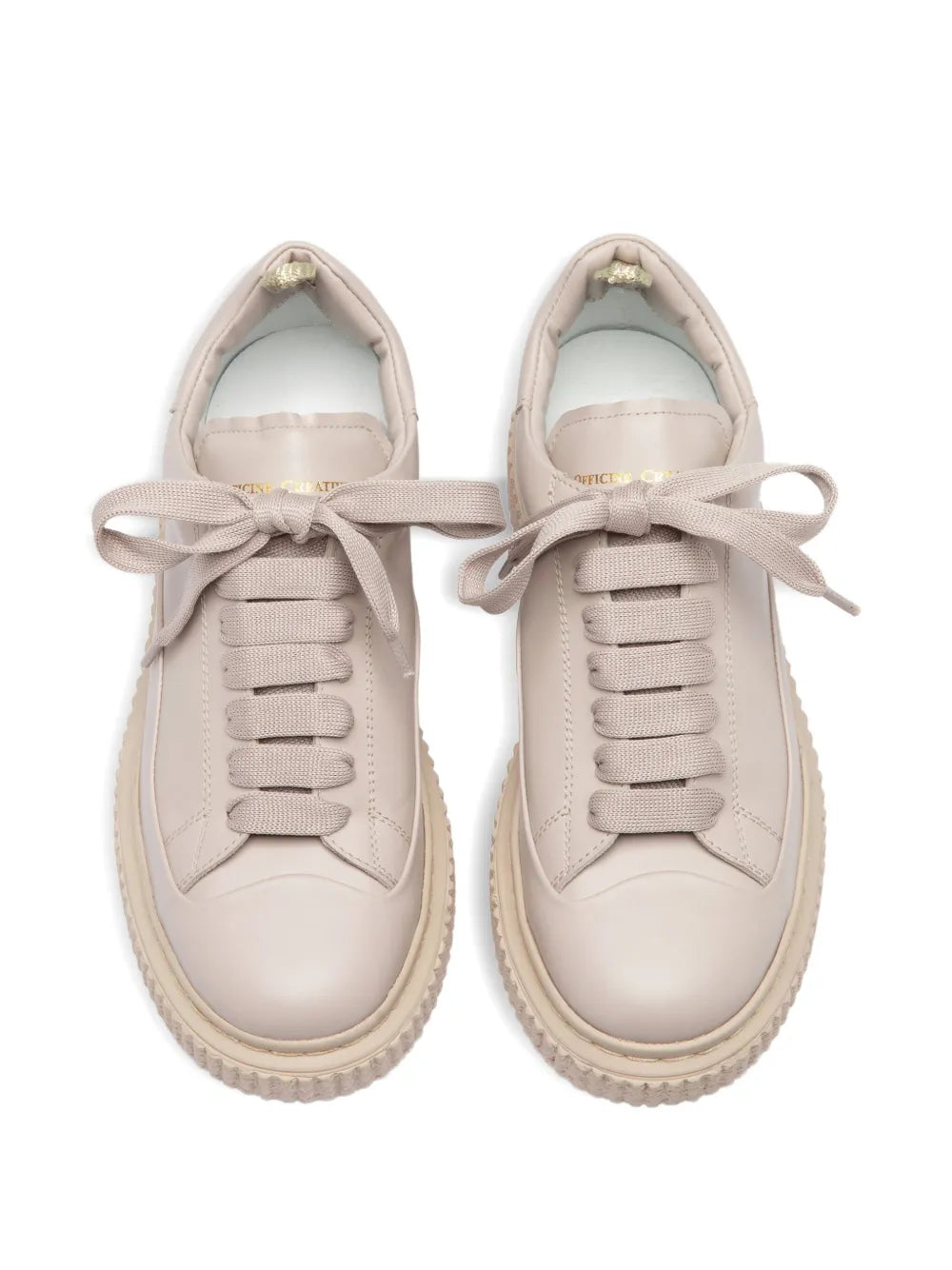 Pair of beige leather sneakers with lace-up ties and cushioned tongue