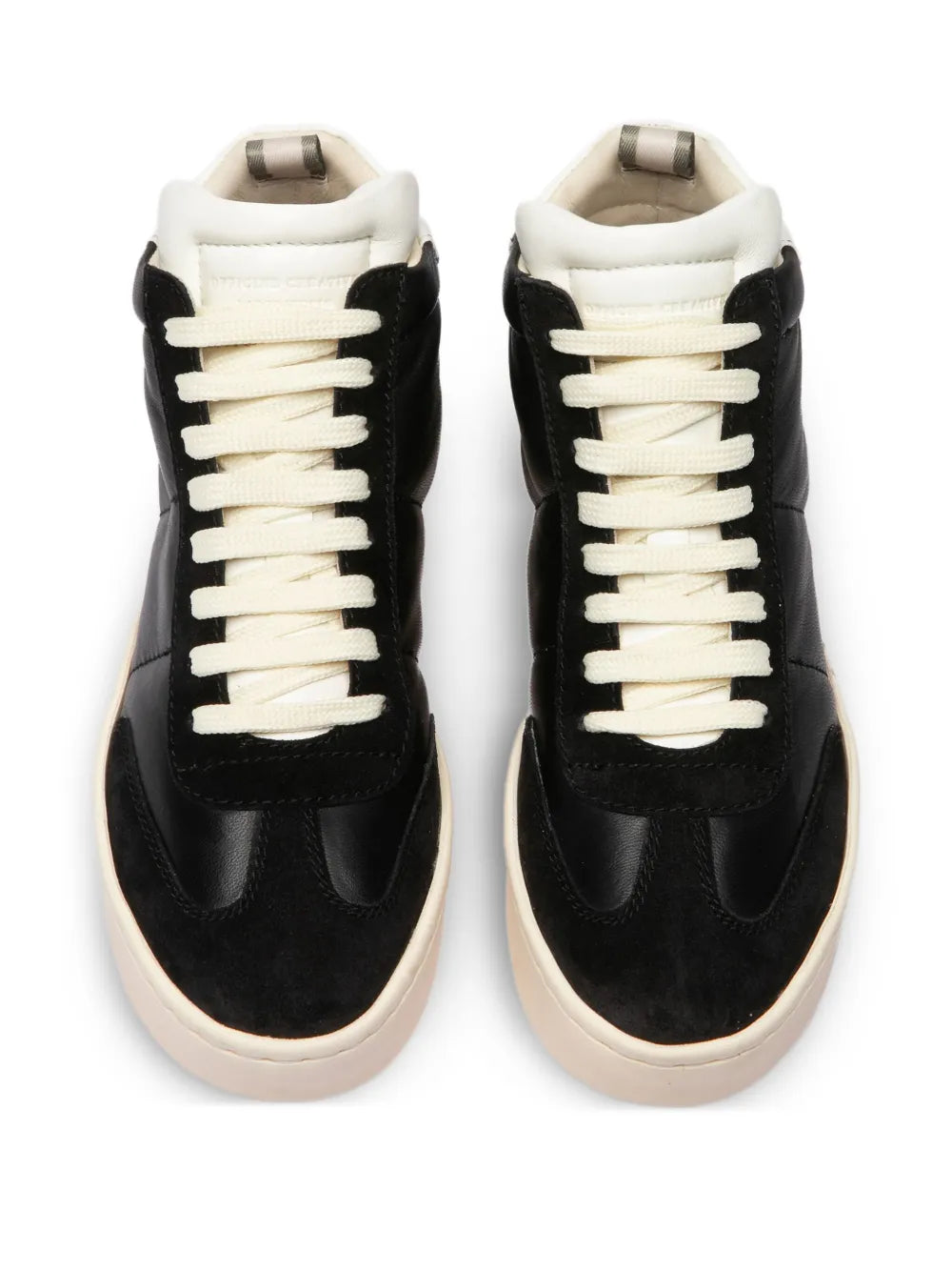 Pair of black high-top sneakers with cream laces and white collar lining