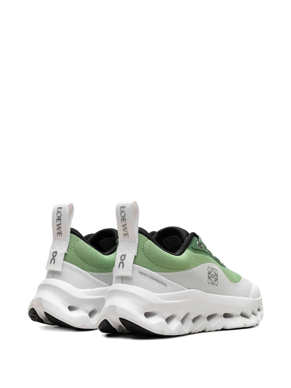 Green and white sneakers from heel view with branded pull tab and padded collar