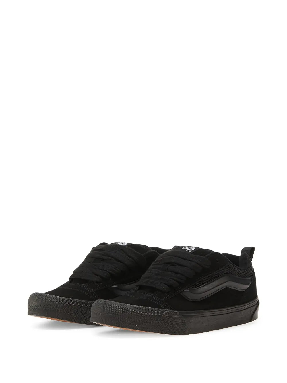 Black low-top lace sneakers with Vans side stripe and thick rubber outsole