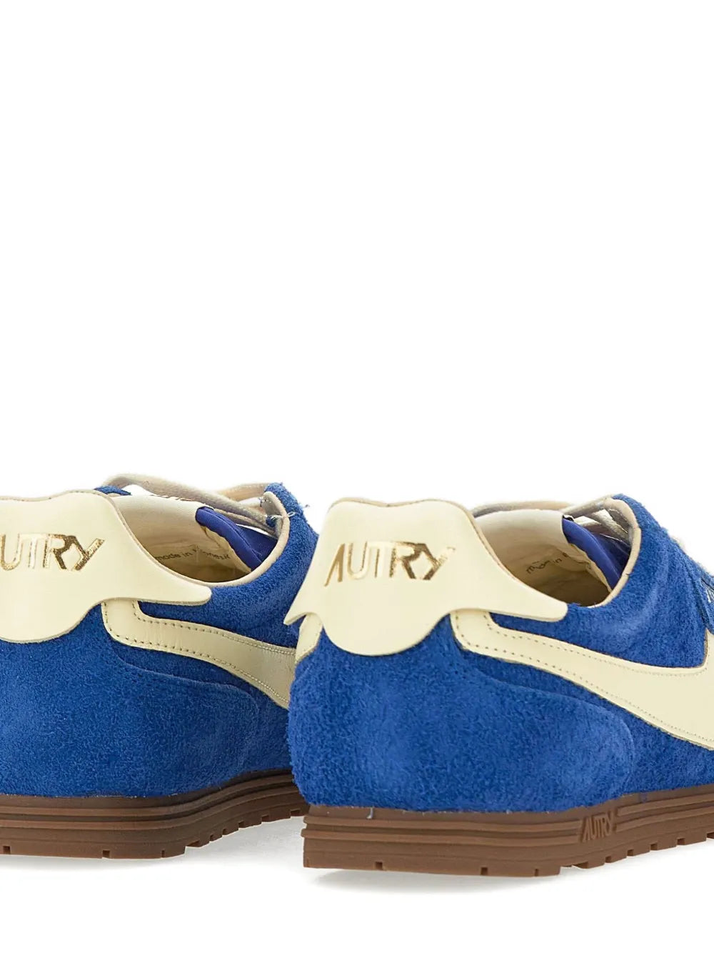 Back view of royal blue suede leather sneakers with cream heel tabs and AUTRY