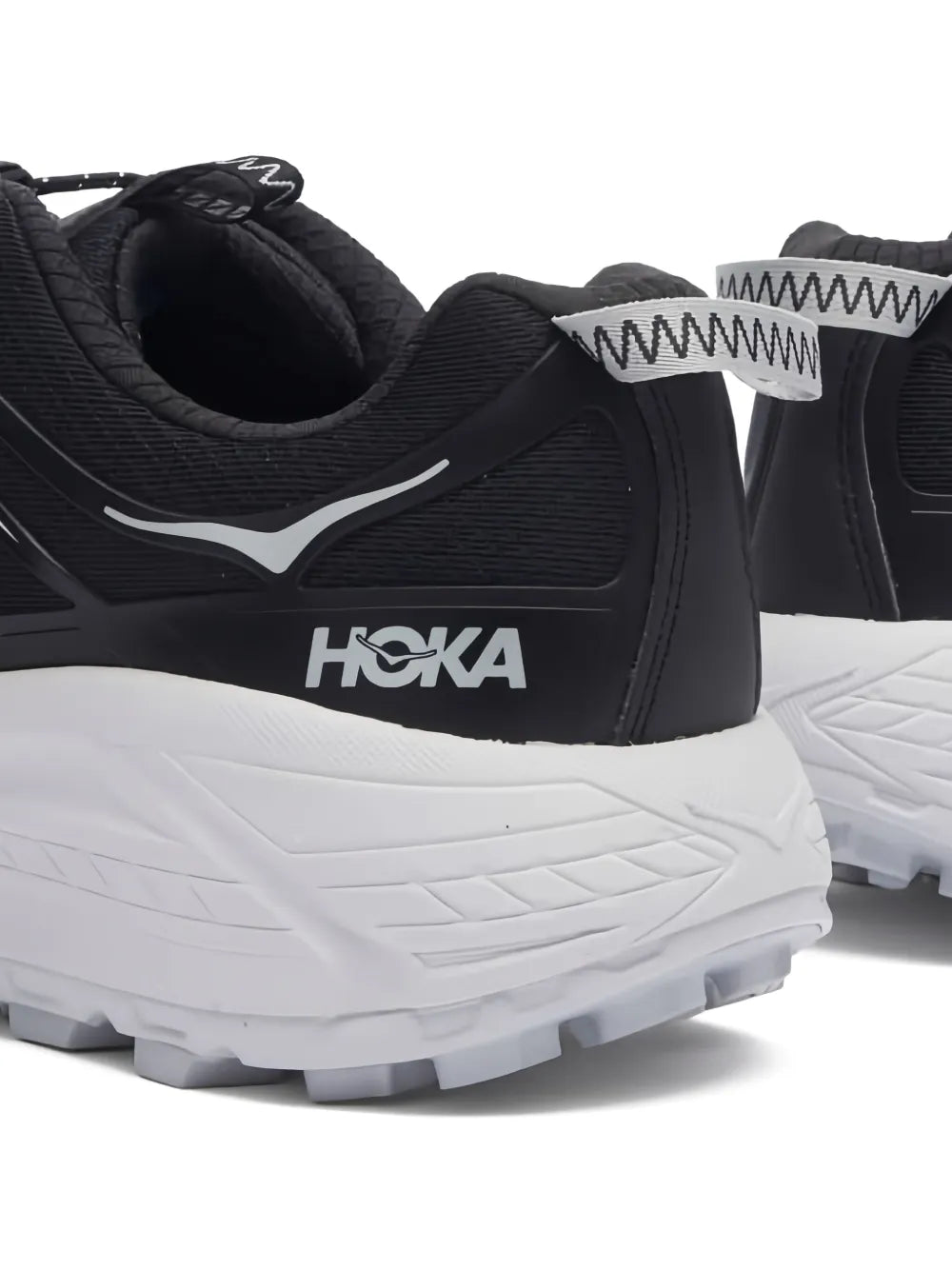 Black Hoka sneakers with padded collar, heel pull tab, and white midsole