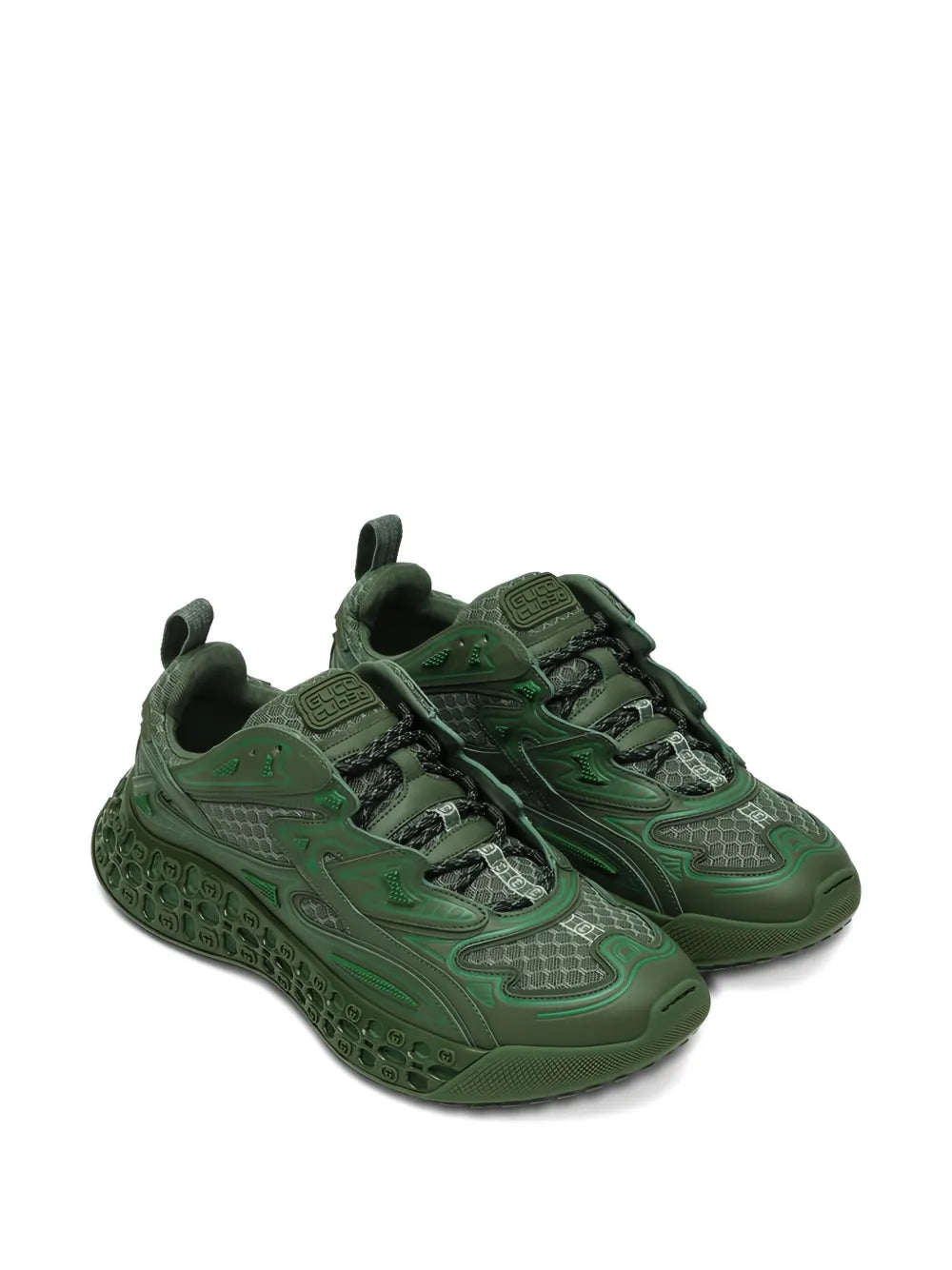 Dark green Gucci sneakers with sculpted sidewall panels and dual-lace design.