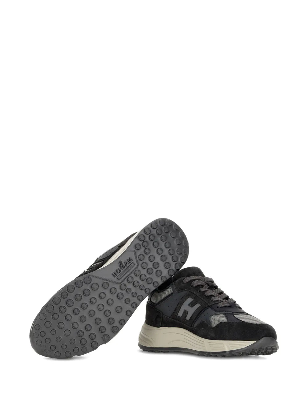Sneaker outsole view with textured rubber tread and beige platform