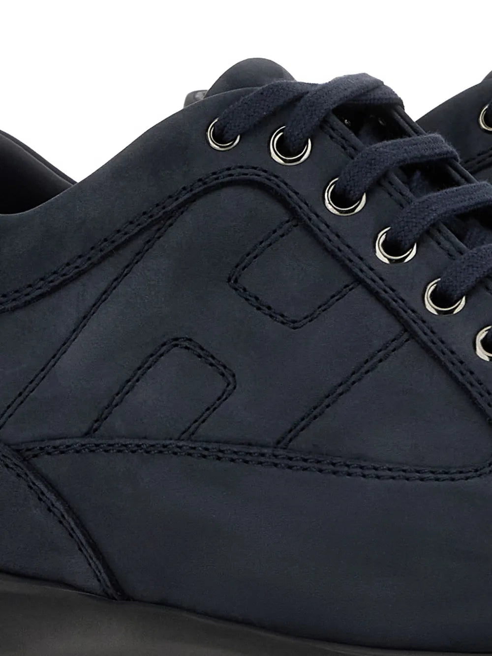 Hogan interactive sneakers close-up: midnight blue upper with stitched panels and lace eyelets