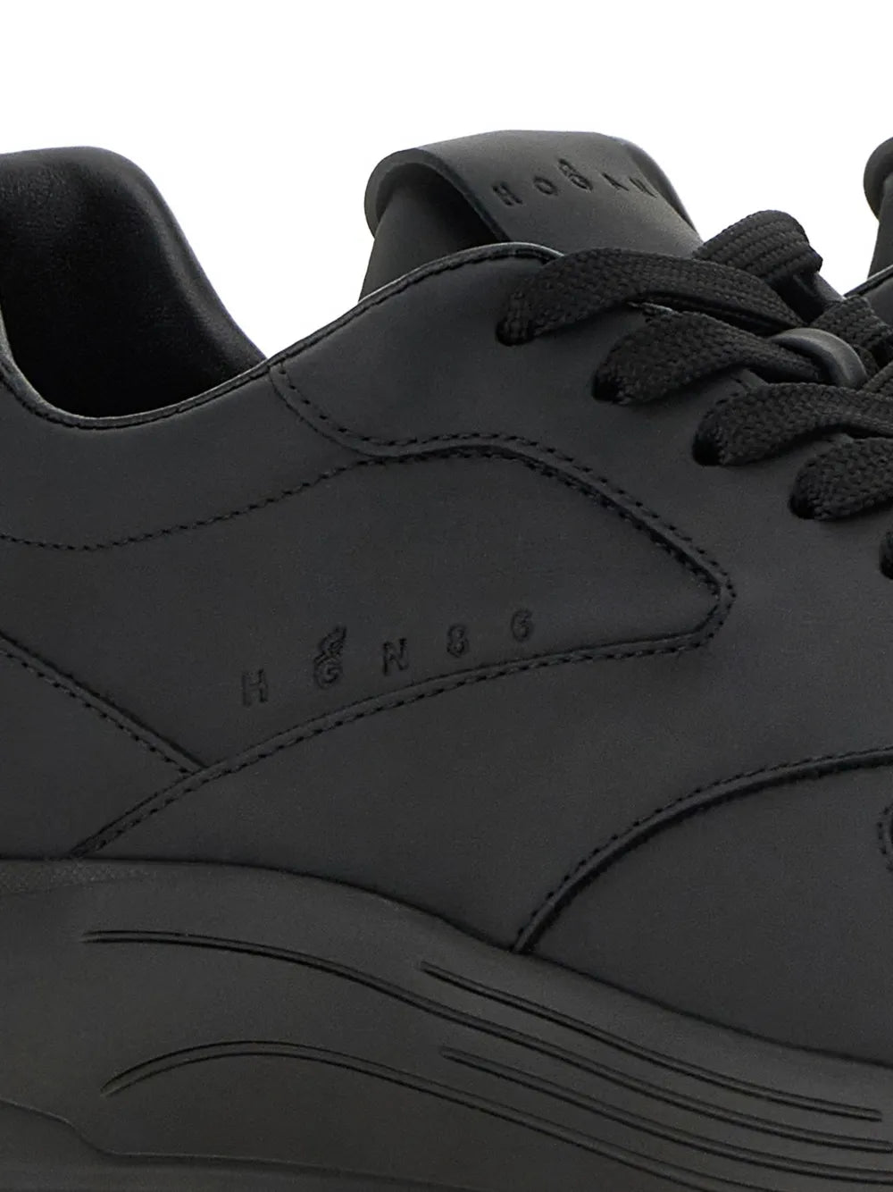 Black sneaker upper detail with stitched panels and Hogan branding