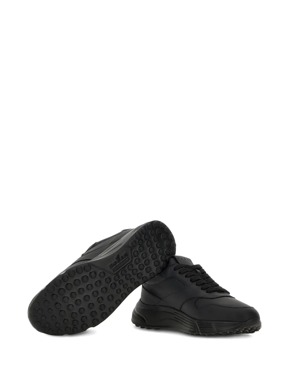 Black low-top sneakers outsole view with textured rubber tread