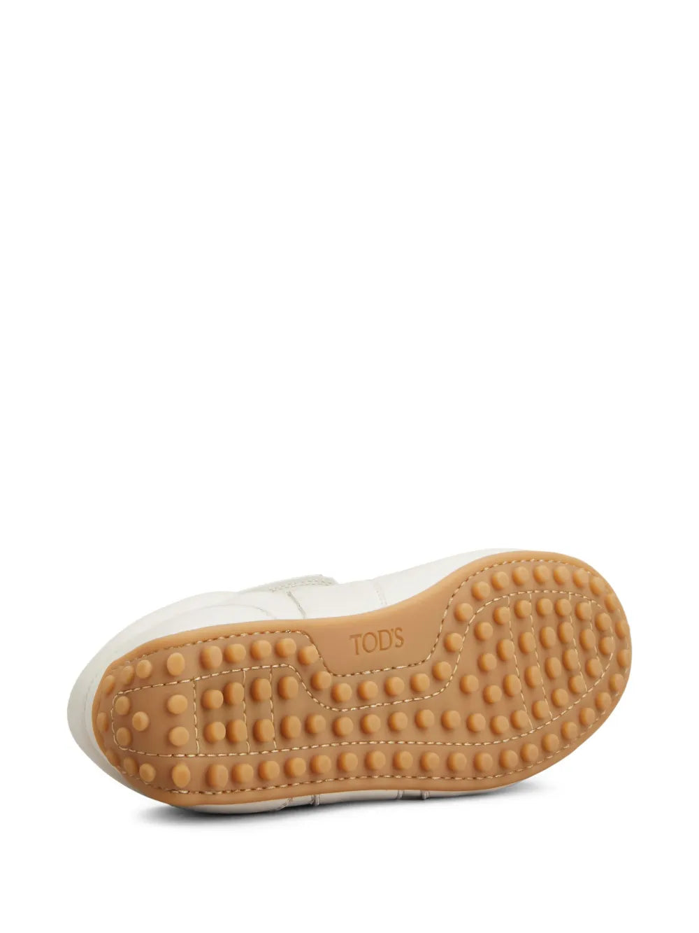 Beige leather sneaker with textured gum rubber outsole and curved toe profile