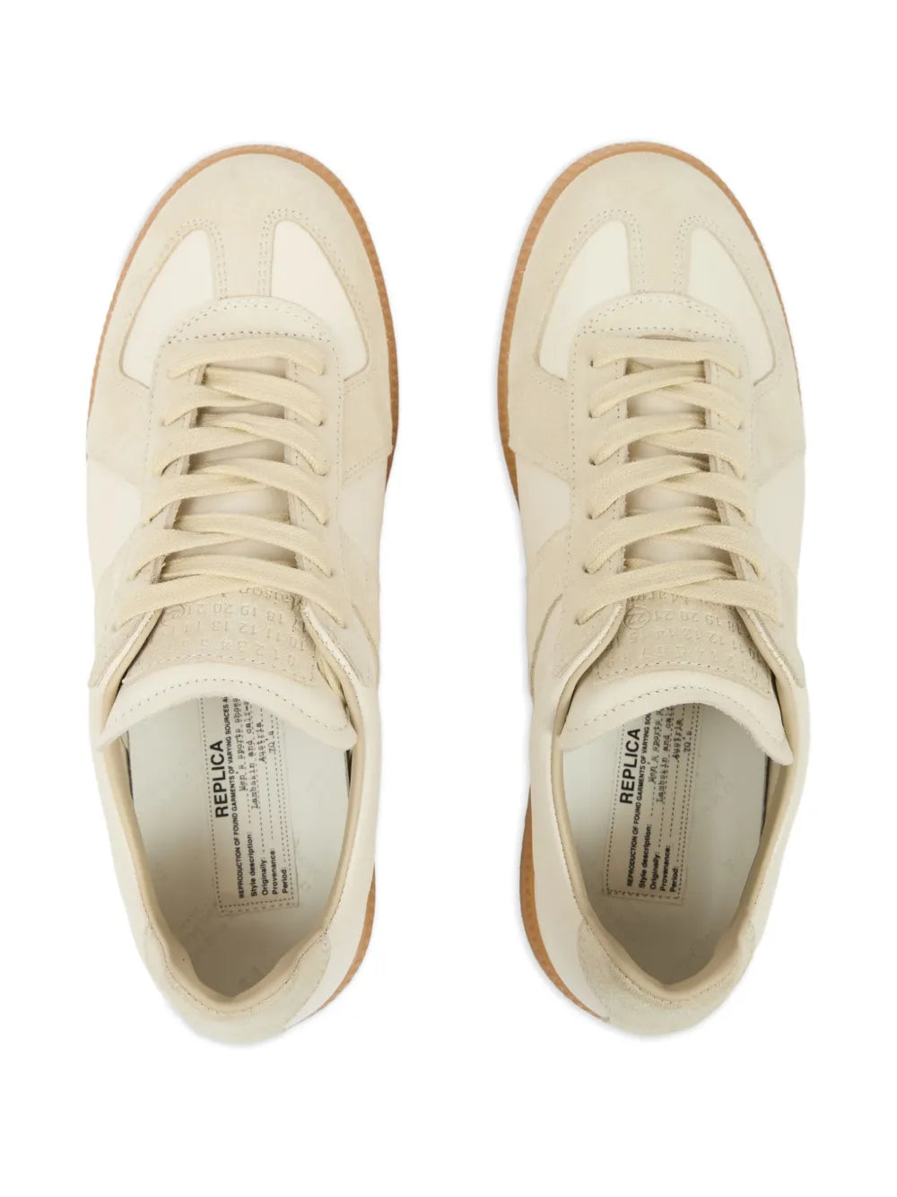 Beige low-top sneakers with lace-up front and interior label near tongue