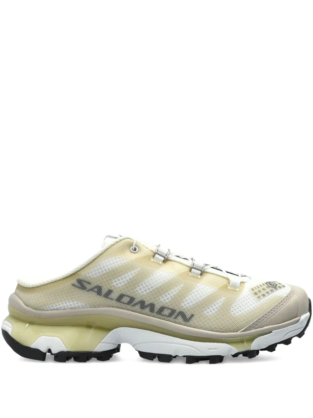 Beige low-top lace-up sneakers with mesh panels and chunky black tread sole