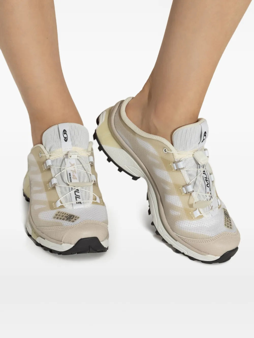 Beige lace-up sneaker mule on feet with black-and-white outsole details