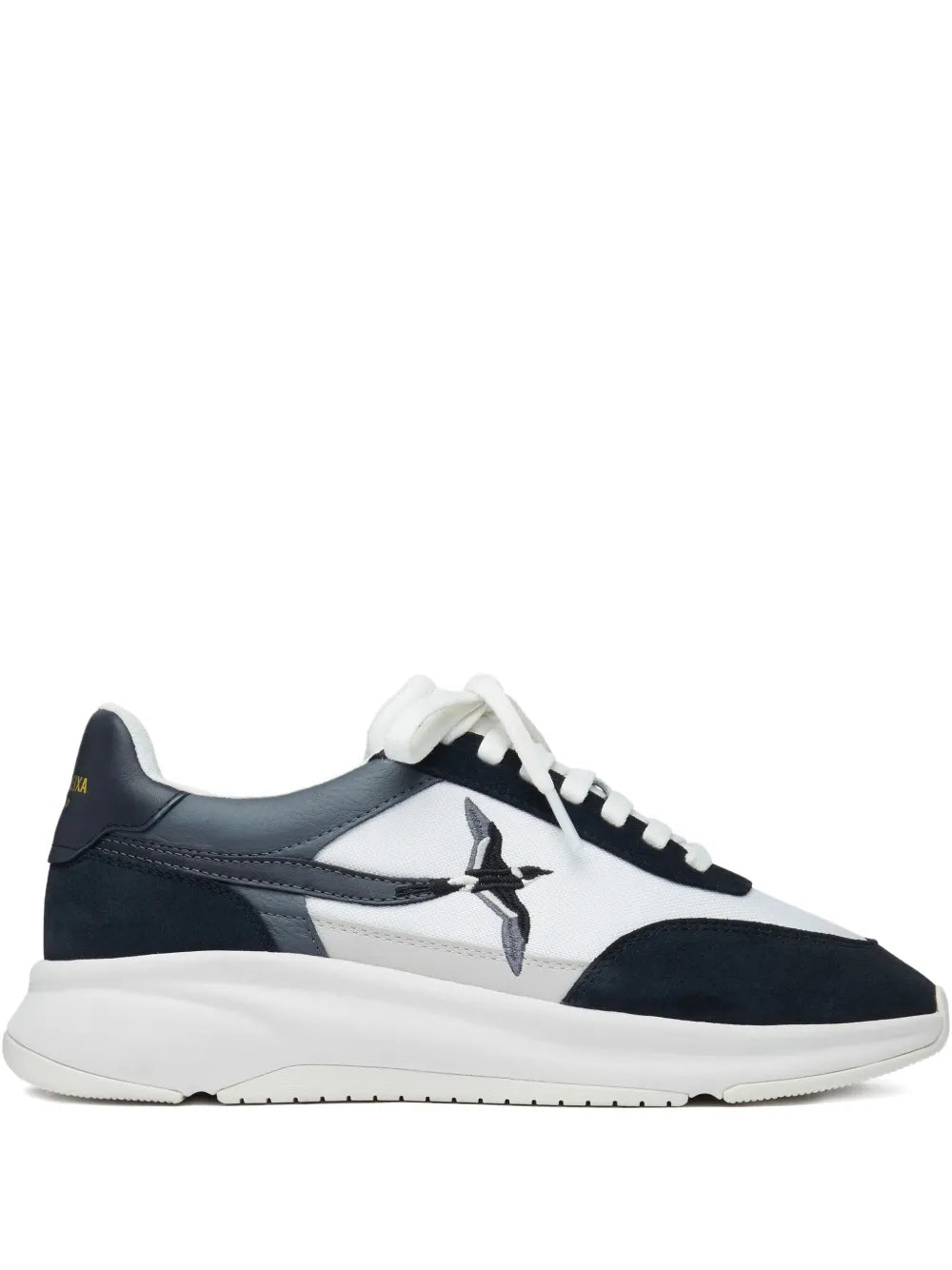 White and navy runner sneakers with bird logo, lace-up front.