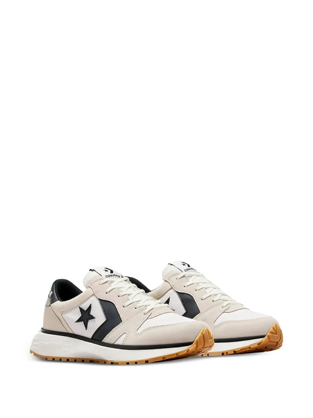 Pair of beige low-top sneakers with black side panels, star patch, and gum soles