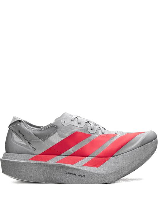 Grey lace-up running shoe with red three-stripe design and thick cushioned sole