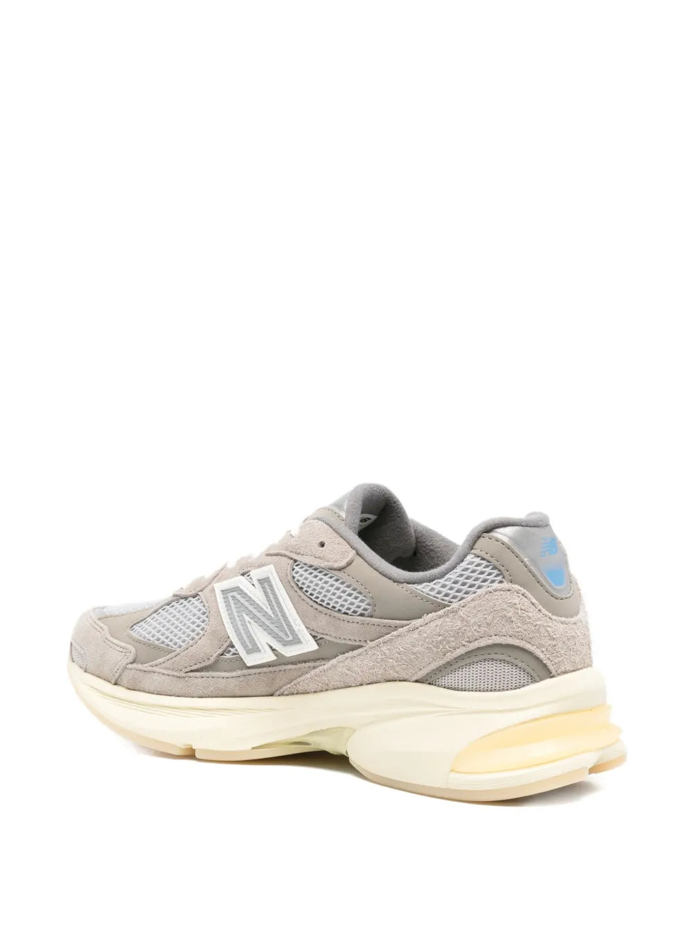 Grey New Balance 2010 sneakers with mesh back, suede overlays, and cream cushioned midsole