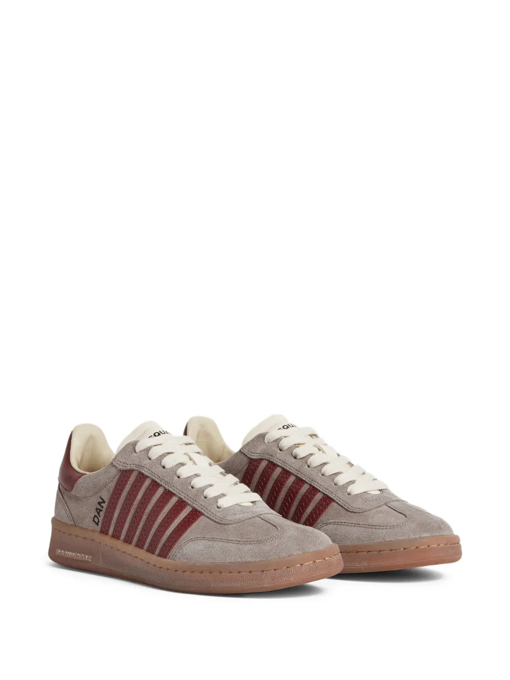 Taupe low-top sneakers with red striped side panels, white laces, and brown sole