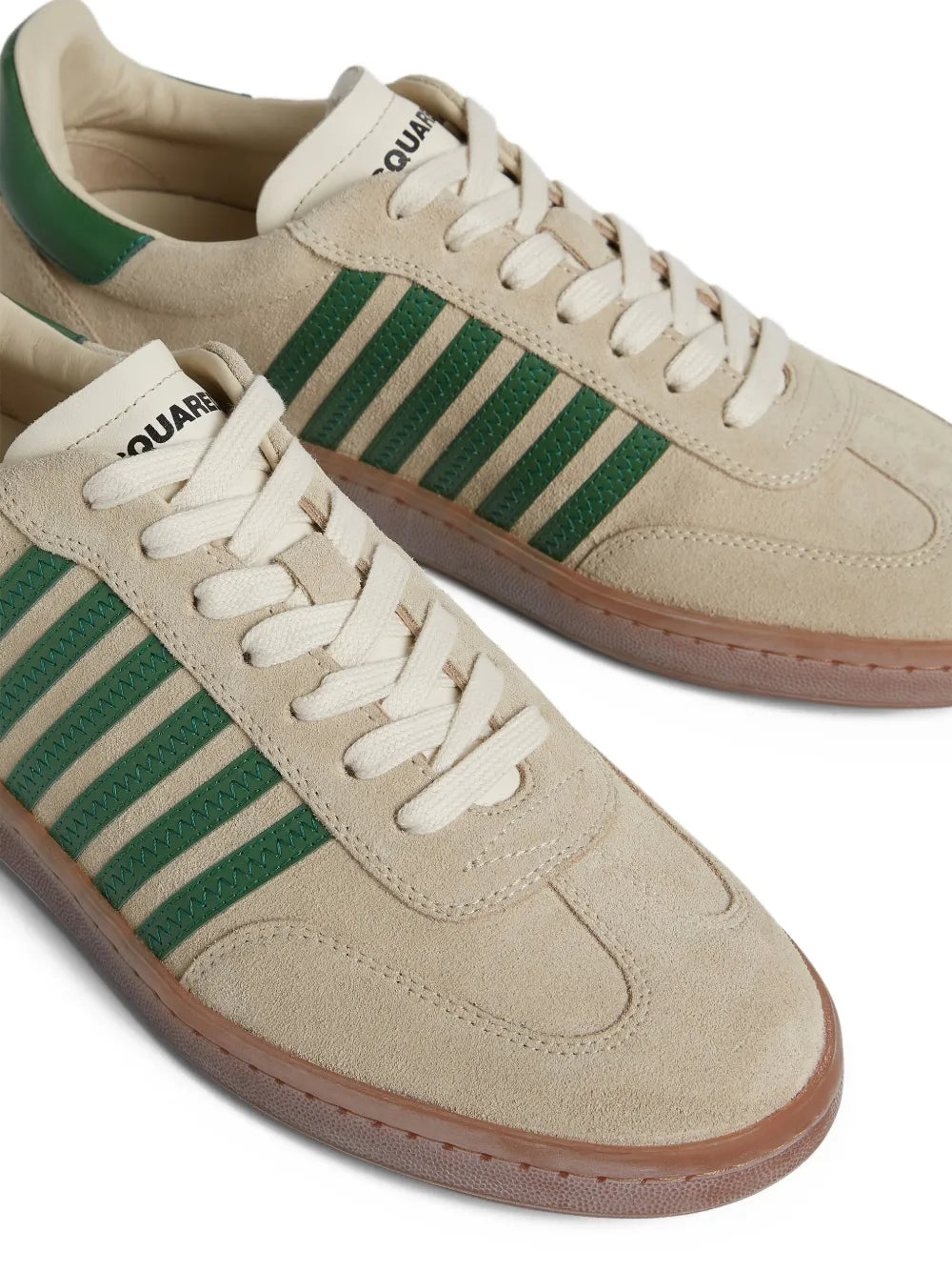 Beige suede lace-up sneakers with green striped panel and white laces.