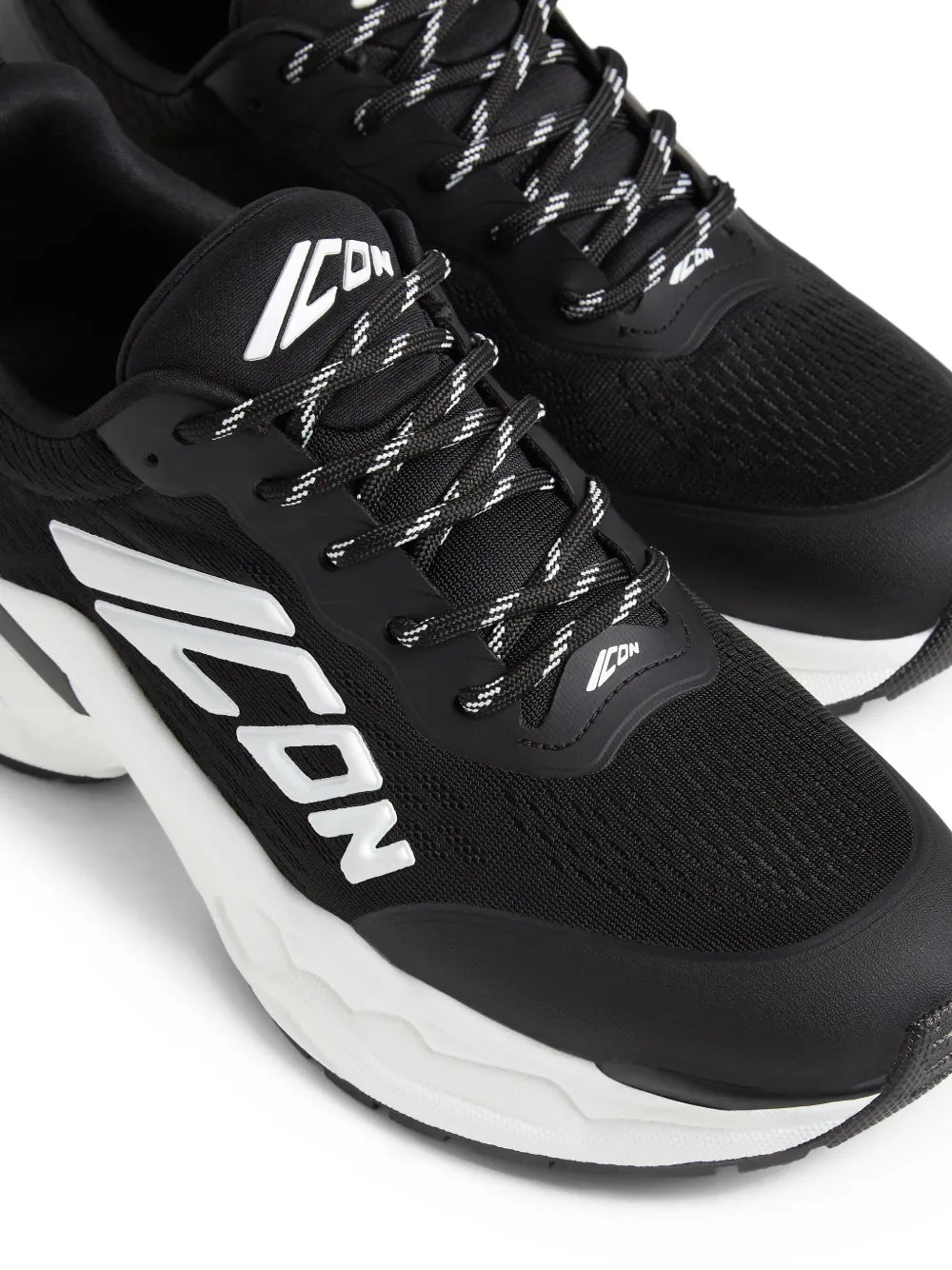 Black Dsquared2 Fly sneakers close-up with ICON logo, black knit upper, and white sole